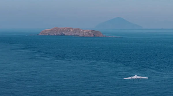 写真：島に向かって海上を飛行する固定翼ドローン