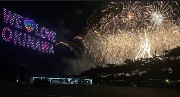 写真：打ち上がる花火と、ドローショーで夜空に描かれた「WE LOVE OKINAWA」
